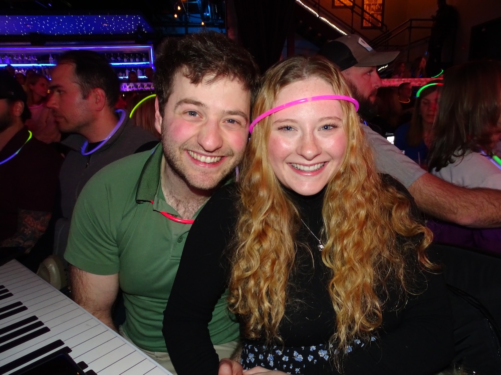 DC Couple celebrating a birthday party celebration at Bobby McKey's Dueling Piano Bar, with drinks, live music, and dancing.